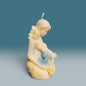 Enchanted Wicks Motherhood sculpted pillar candle in creamy wax with blue baby detail and floral accents.