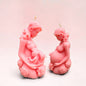 Enchanted Wicks pink sculpted pillar candles featuring mother and child figures with delicate floral details.